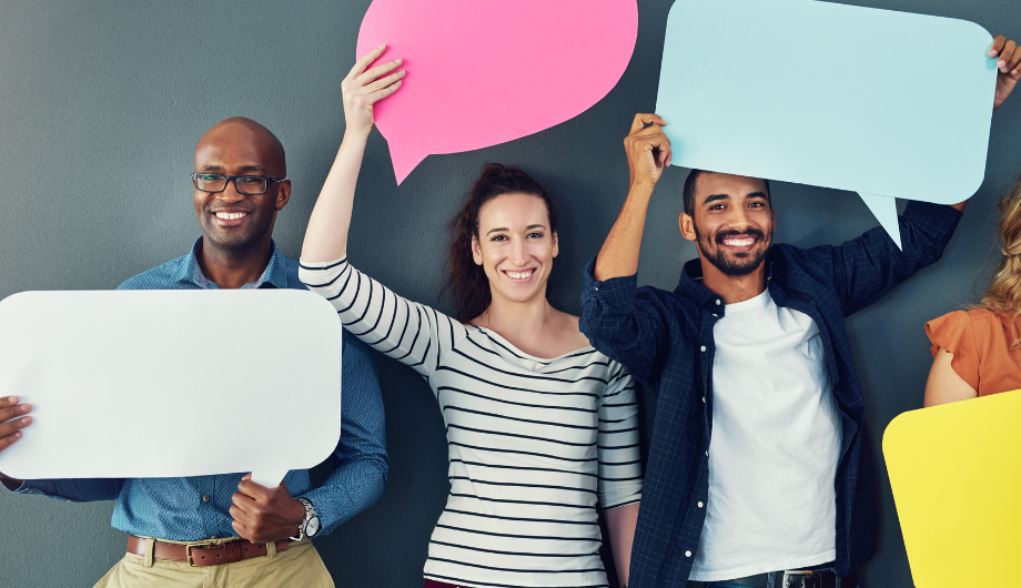 Group of men and women holding up speech bubbles