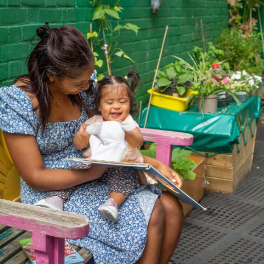 Teacher and baby reading with puppet