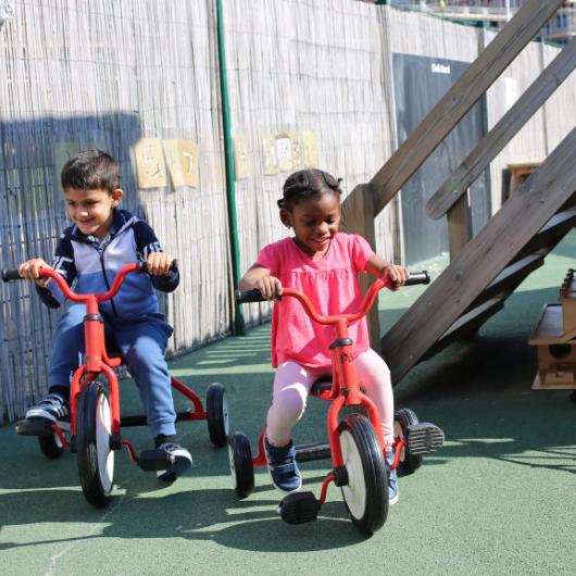 children riding bikes in the garden