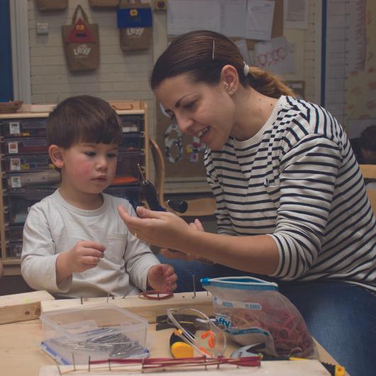 Teacher doing construction activity with child