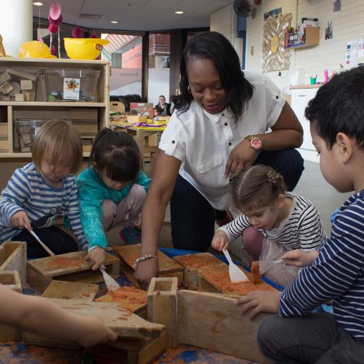 Teacher doing construction activity with children