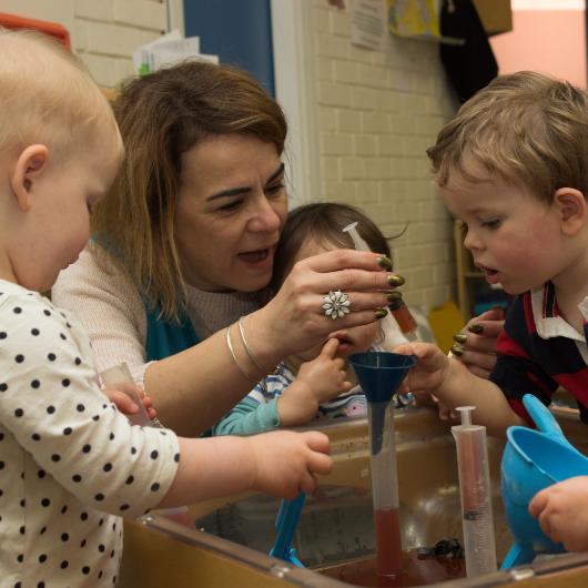 Teacher doing science experiment with children