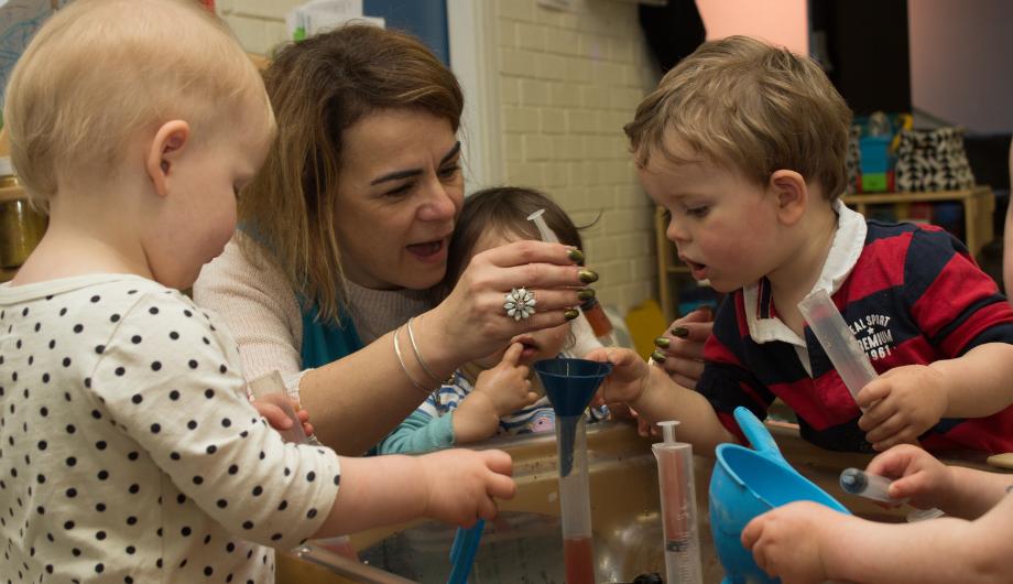 Teacher doing science experiment with children