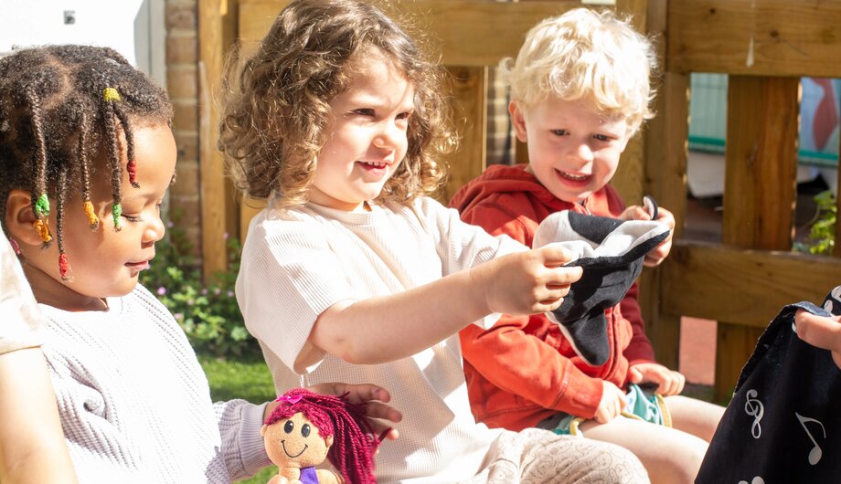 Children playing with soft toys as a language activity