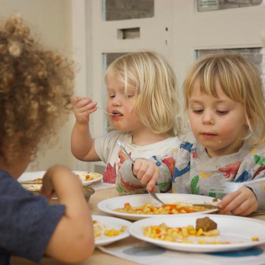 Children eating a meal in the nursery