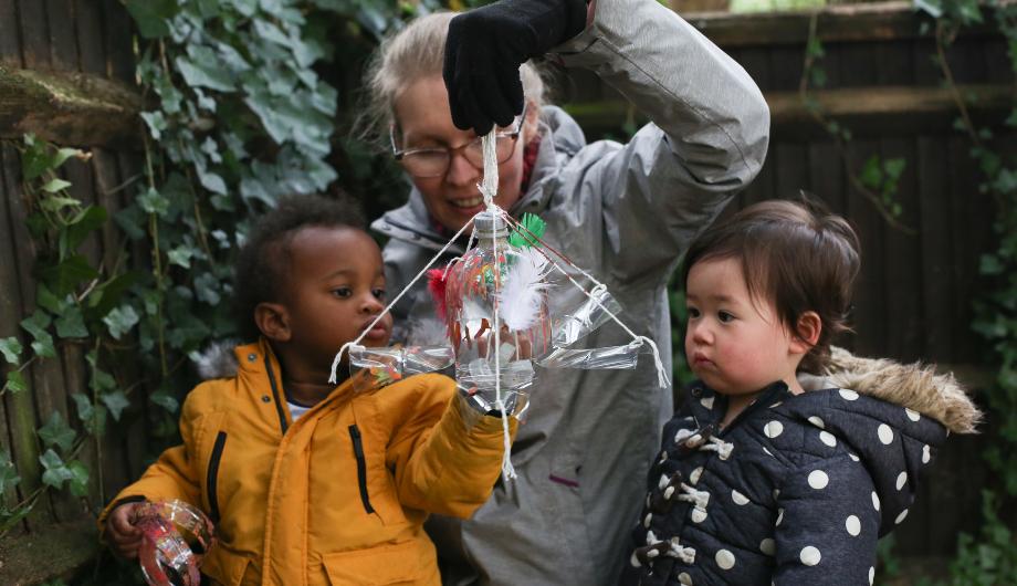 Sustainability activity with teacher and children in garden