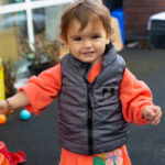 Smiling toddler in the nursery garden