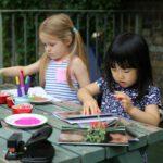 Children sitting down drawing - Square