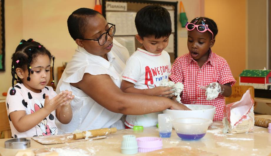 Staff and children enjoying some messy play with flour and water