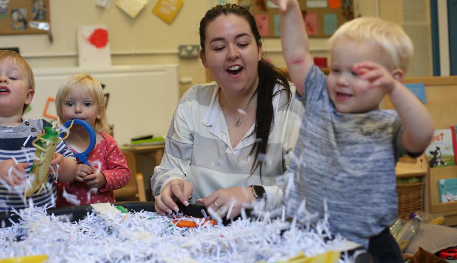 Child playing with messy paper provocation