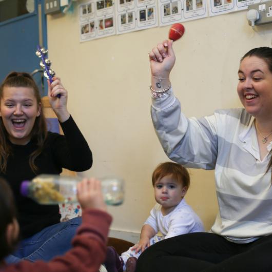 Staff and children playing with musical instruments