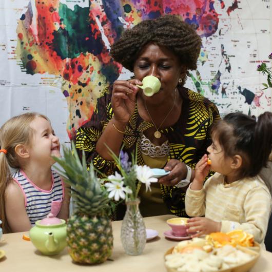 Staff member having tea party with children