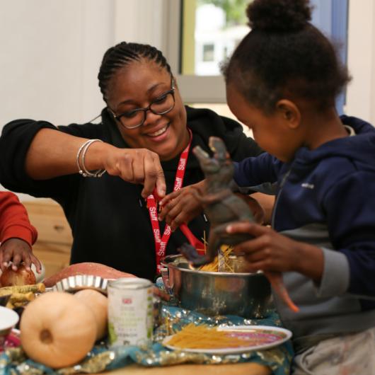 Teacher and children making art from food