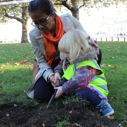 Child and teacher gardening in the nursery garden