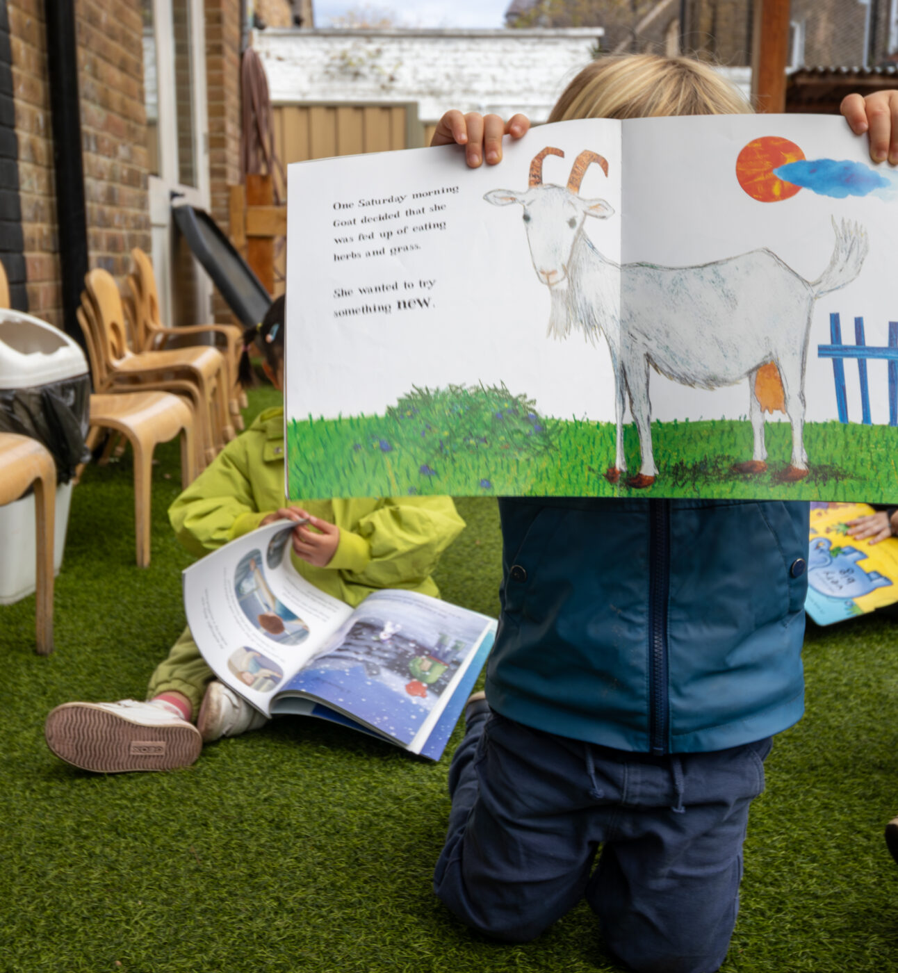 Micky Star Nursery child holding up book