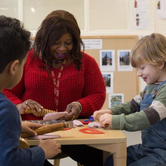 Staff and Child playing with playdough