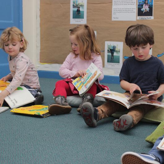 Children reading sitting on the floor