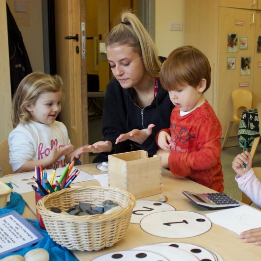 Staff and children learning how to count