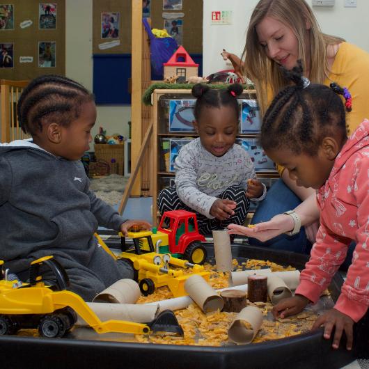 staff and children playing with trucks, an cornflakes