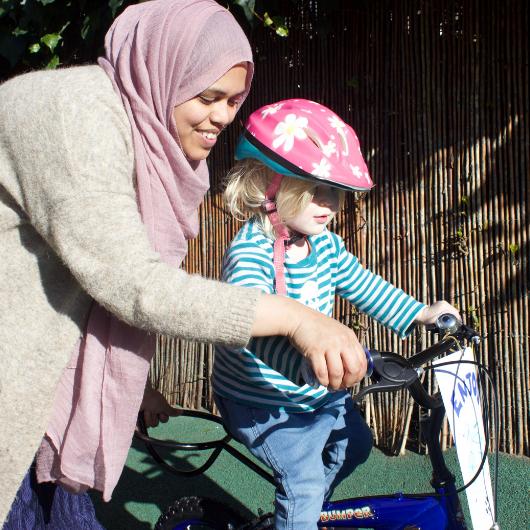 staff helping a child ride a bike from Bikeworks