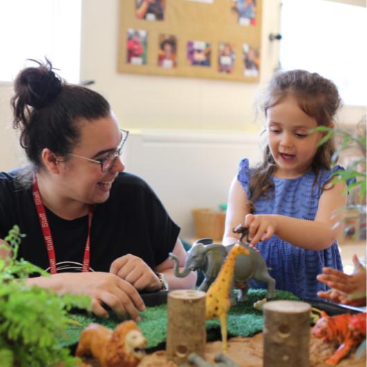 Staff and child playing with a provocation