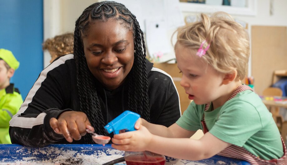 Children and staff playing with flour in tuff tray