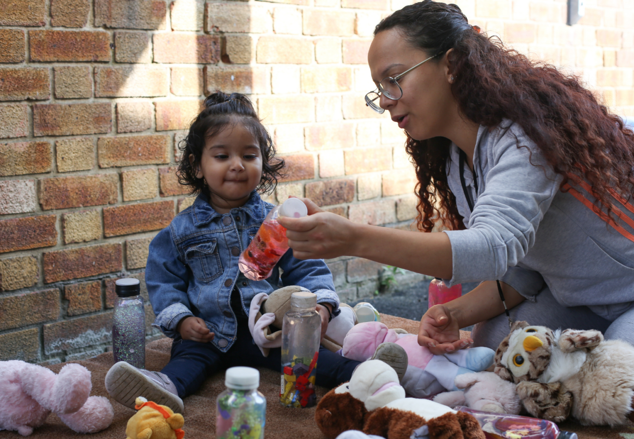 Staff showing a child a sensory bottle