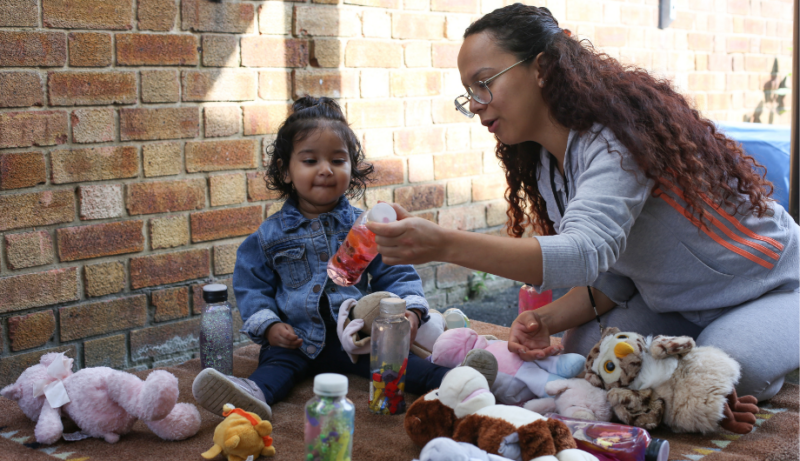 Staff showing a child a sensory bottle