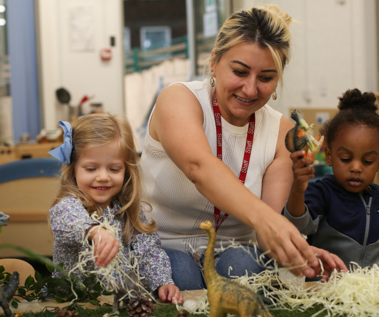 staff and children playing with some natural resources during a provocation