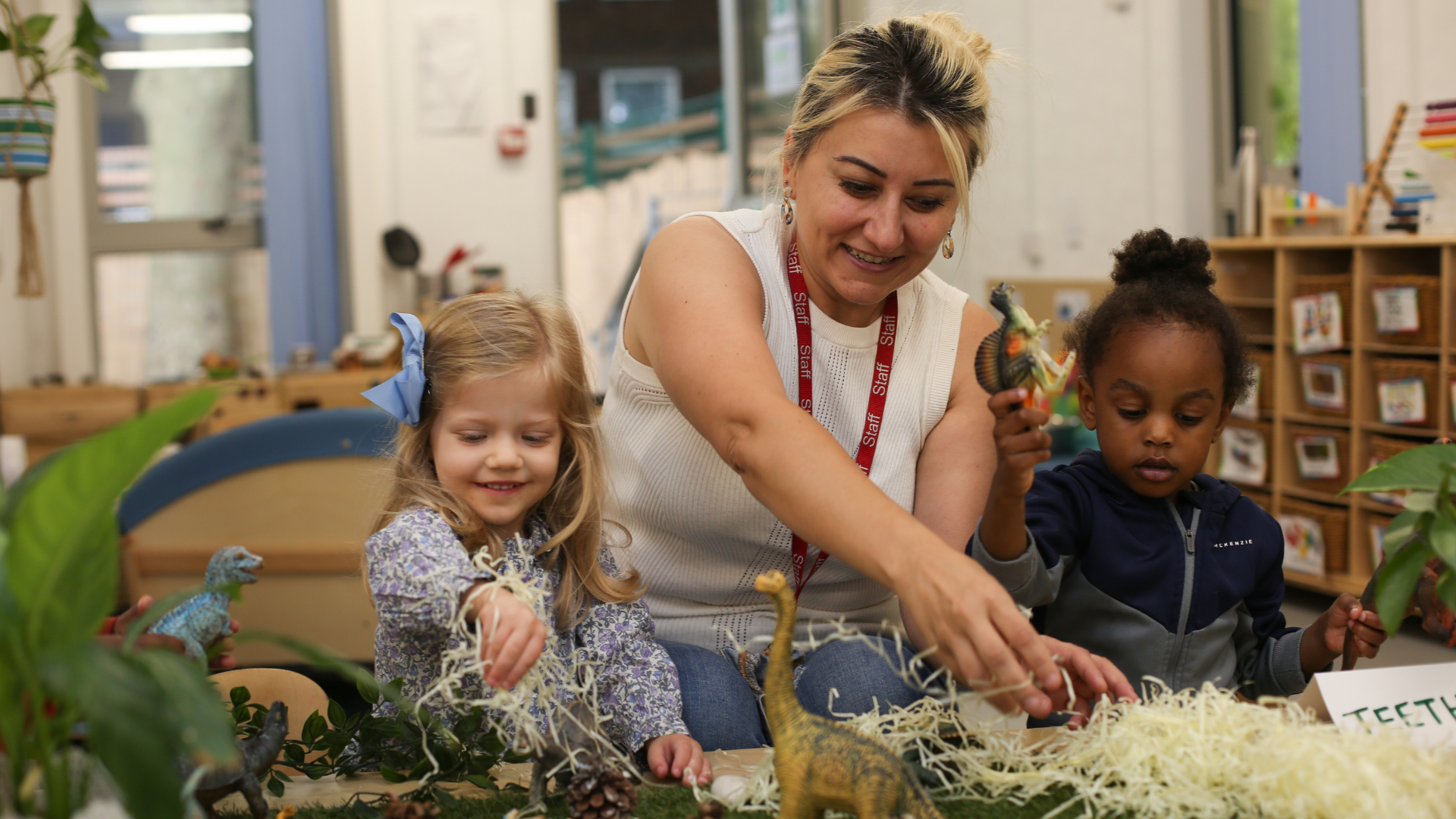 staff and children playing with some natural resources during a provocation