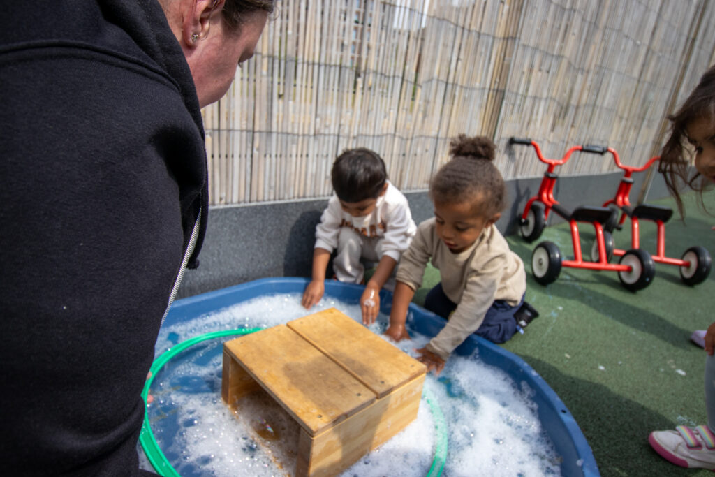 Playing in the paddling pool at LEYF Barking Nursery