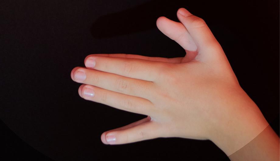 Child's hands making a shadow puppet