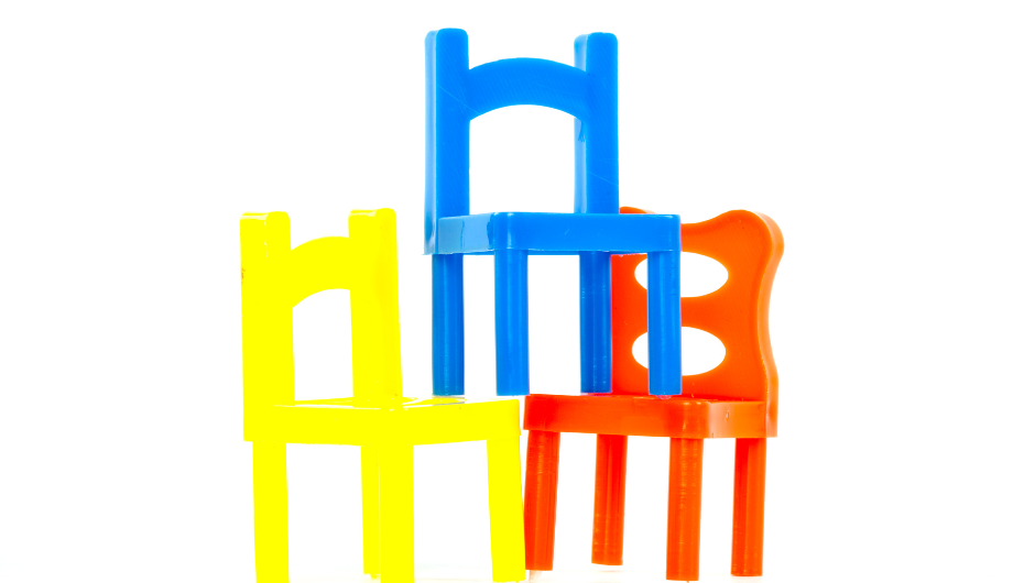 three coloured childrens chairs stacked