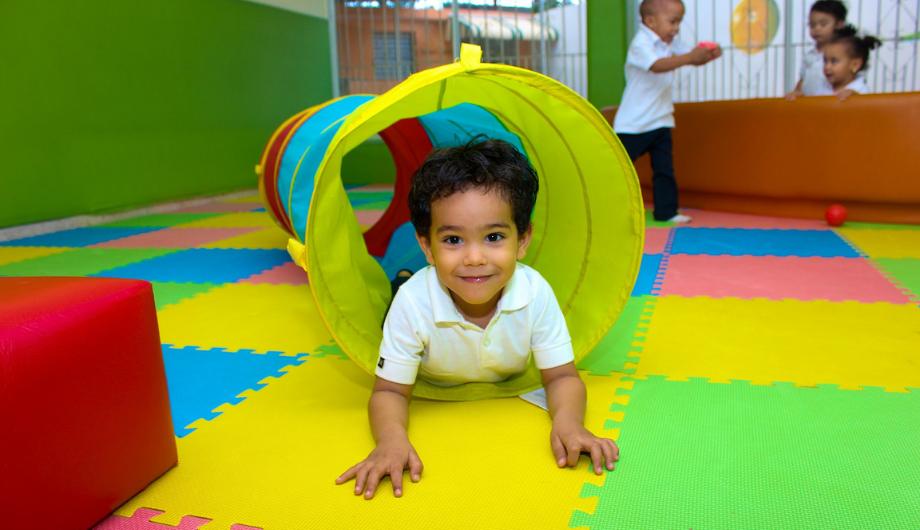 Child crawls through an indoor tunnel