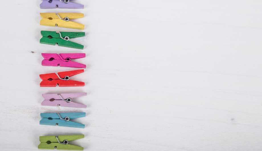 coloured clothes pegs arranged in a vertical line