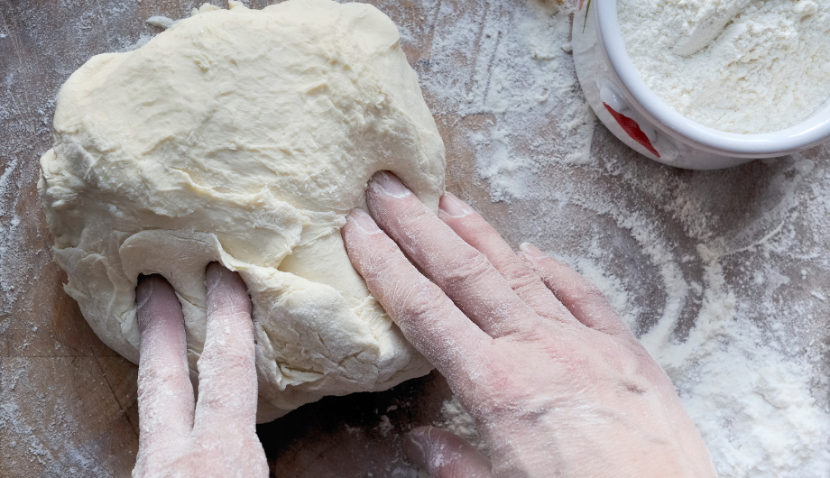 hands kneading dough