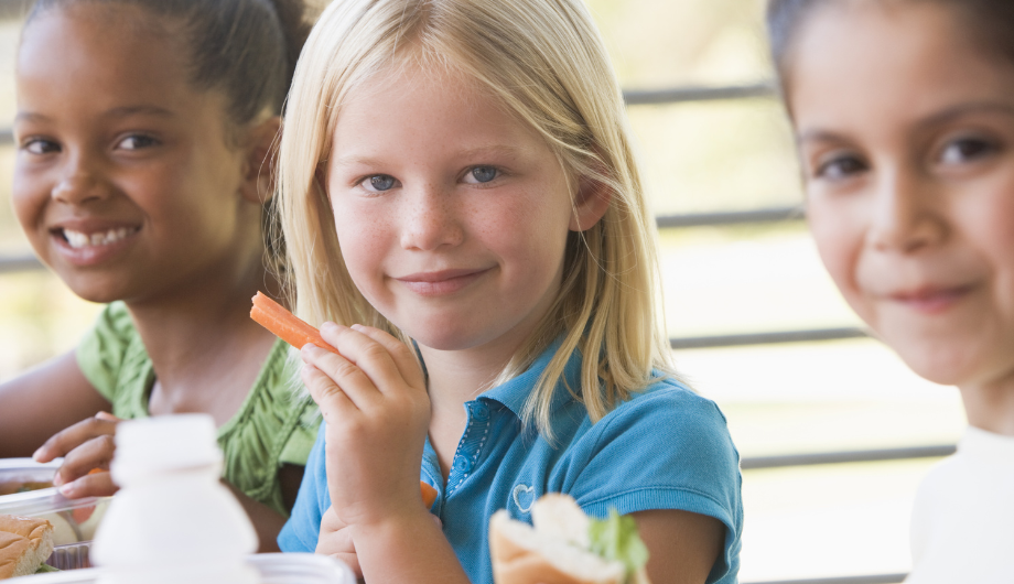 children happily eating healthy food