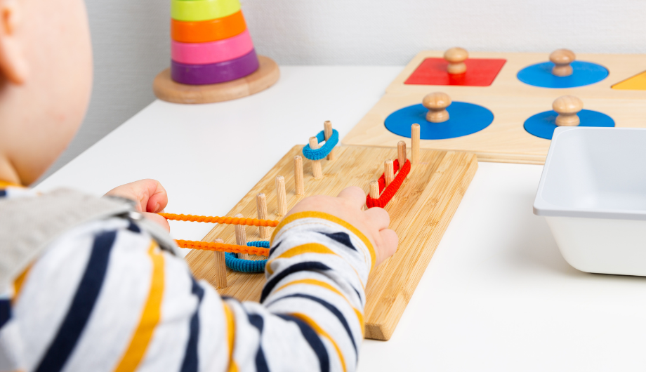 child playing with sensory board