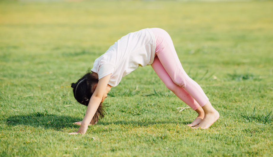 child doing yoga outdoors