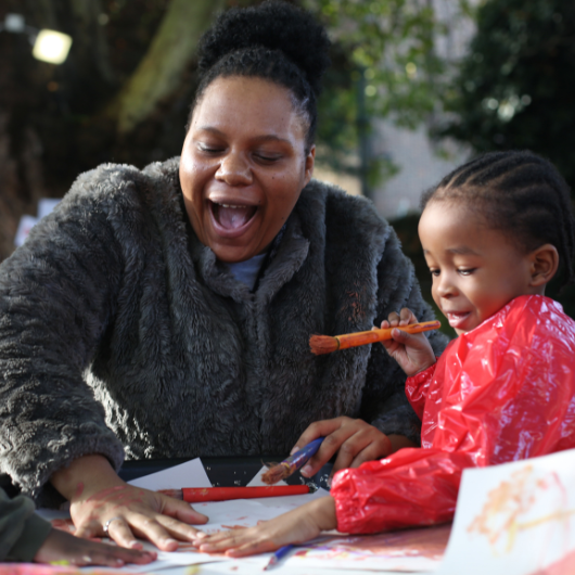 staff and child painting outside