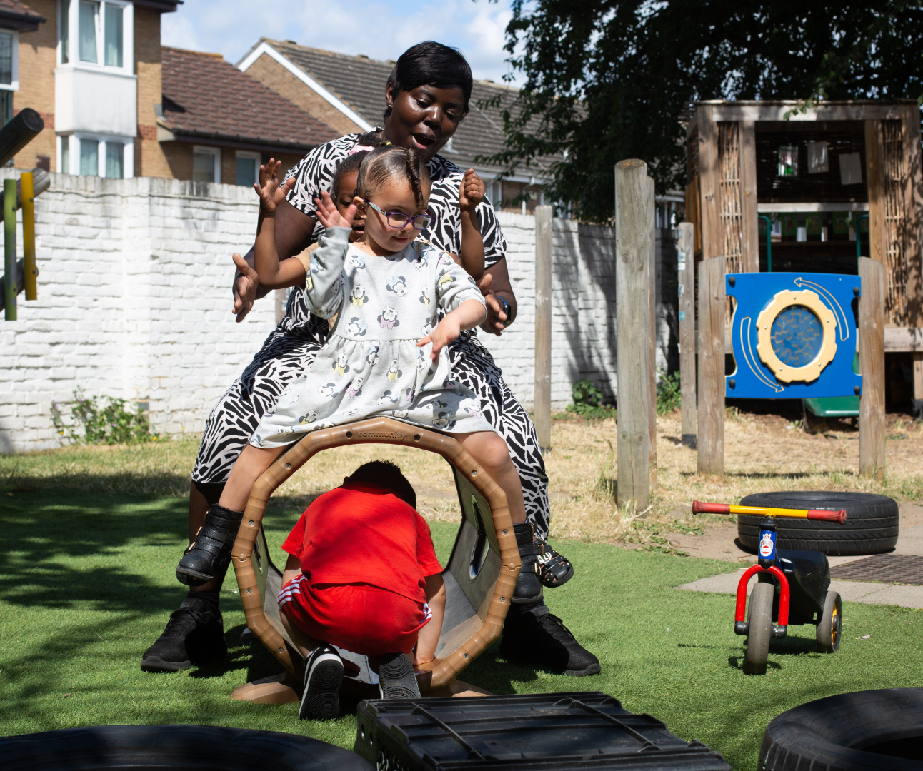 staff and children playing outside in the garden