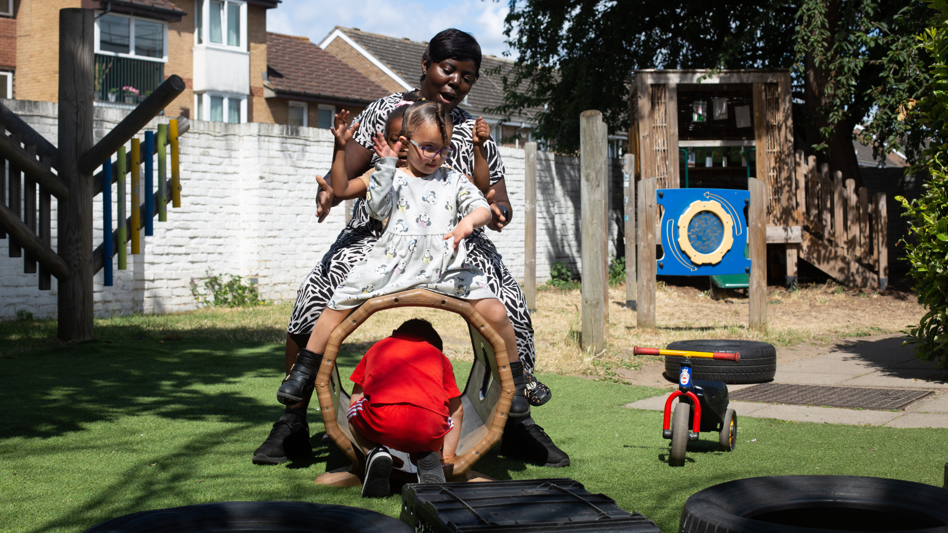 staff and children playing outside in the garden