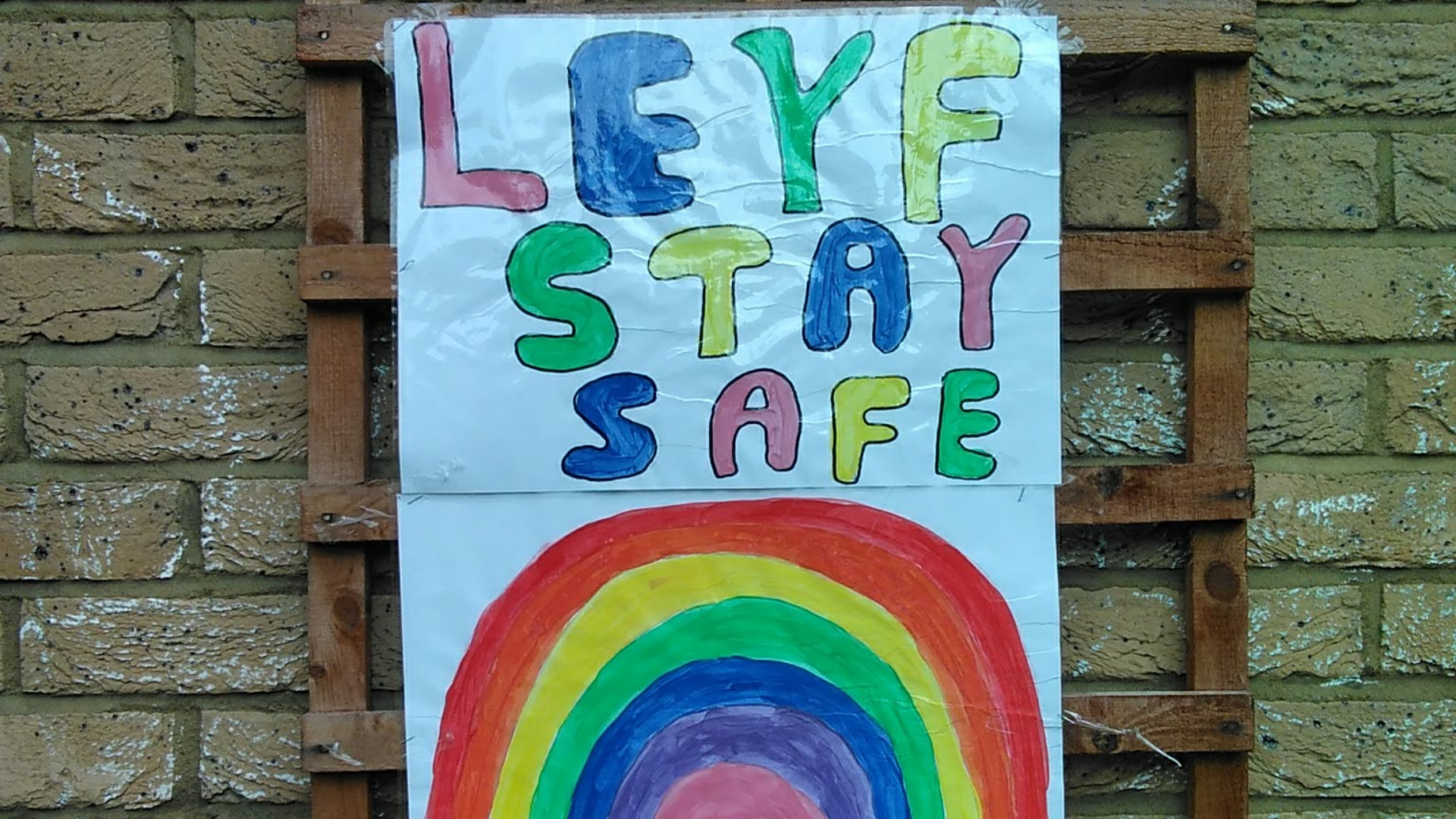 Poster painted by children saying LEYF STAY STAFE with a rainbow