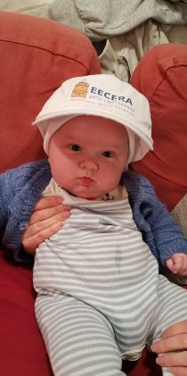 Baby wearing an EECERA cap