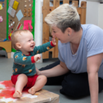 baby laughing at the member of staff