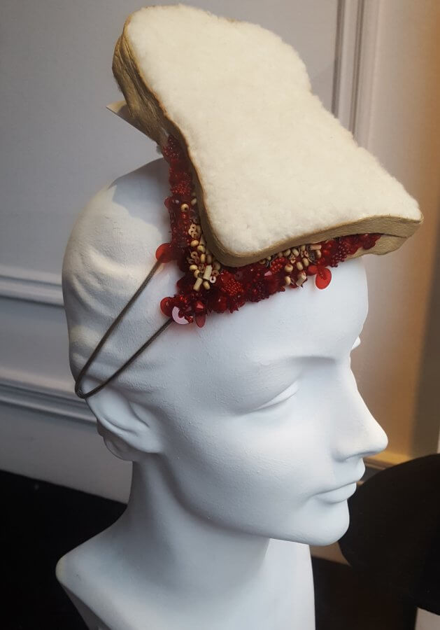 alabaster bust with a hat made to look like a jam sandwich attached to its head