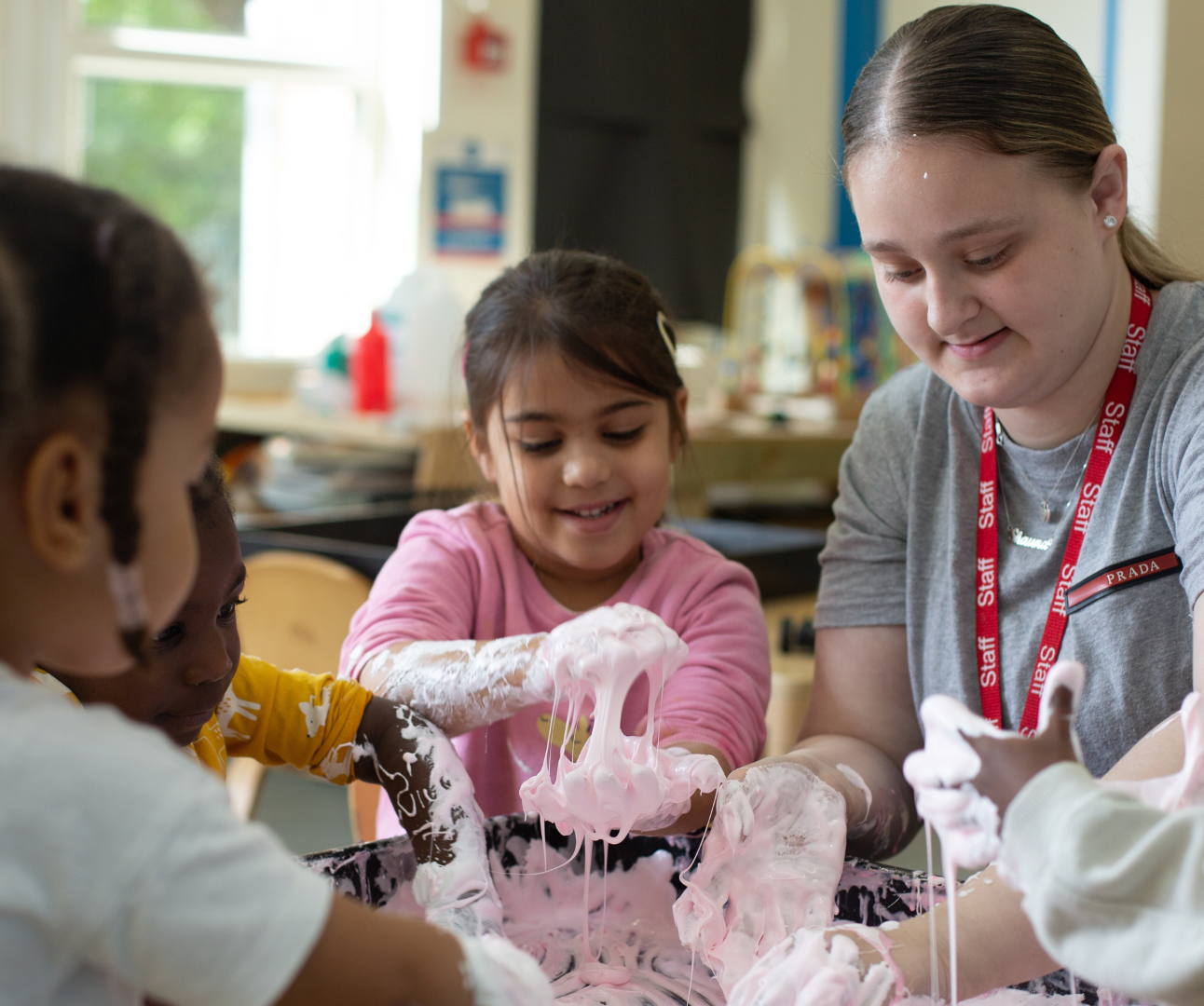 staff and children enjoying messy play with slime