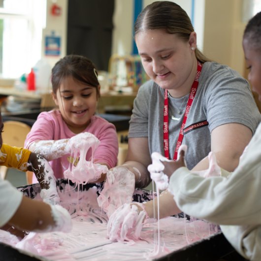 staff and children enjoying messy play with slime