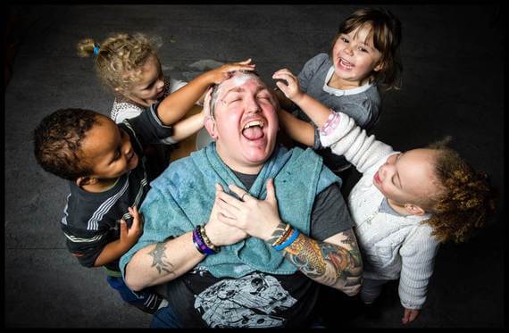 Man having his hair washed by four children