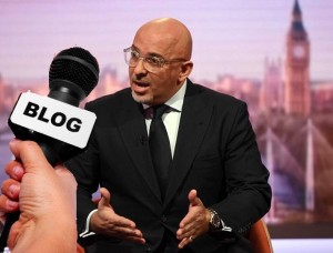 A photo of Nadim Zahawi with a hand holding a microphone with a Blog label on it superimposed as if he is talking to it